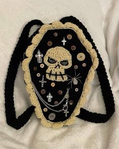 a crocheted purse with a skull on it