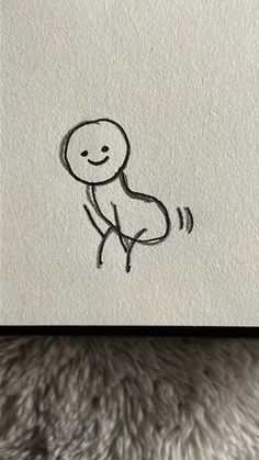 a drawing of a person with a smile on it's face is shown in black ink