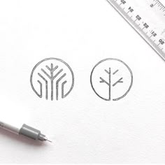 a pen is sitting on top of a piece of paper next to some drawings and a ruler