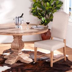 a table with two chairs and a potted plant