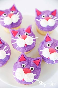 purple cat cupcakes with white icing on a plate