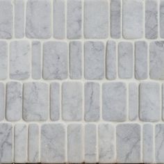 a close up view of white marble tiles