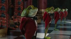 a group of frogs dressed in red suits