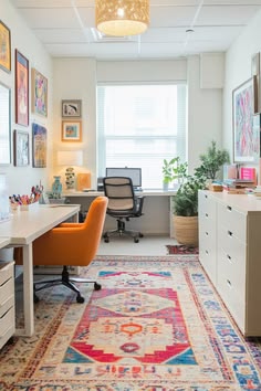 an office with a rug, desk and chair in it's center area is shown
