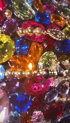 many different colored jewels are on display