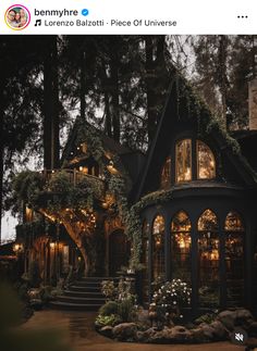 the house is surrounded by greenery and lit up with fairy lights in front of it