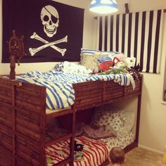 a child's bedroom with bunk beds and pirate decor