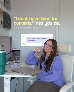 a woman sitting at a desk with a laptop computer