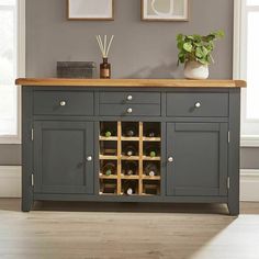 a sideboard with wine bottles on it in a living room