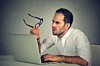 Man confused by laptop