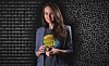 CISA director Jen Easterley standing in front of some binary code