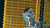 NICER instrument attached to the International Space Station in front of a solar array