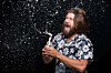 beardy chap pulls beer tab and it sprays in his face