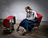 Someone looking bored at an old-school TV