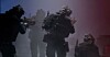 Three armed officers in tactical gear move through smoke in a dimly lit training scene.
