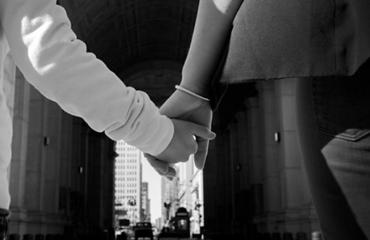 Image of a child and an adult holding hands.