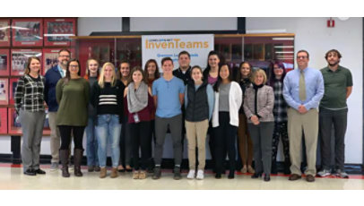 A group of students and teachers standing in front of lockers in a school hallway