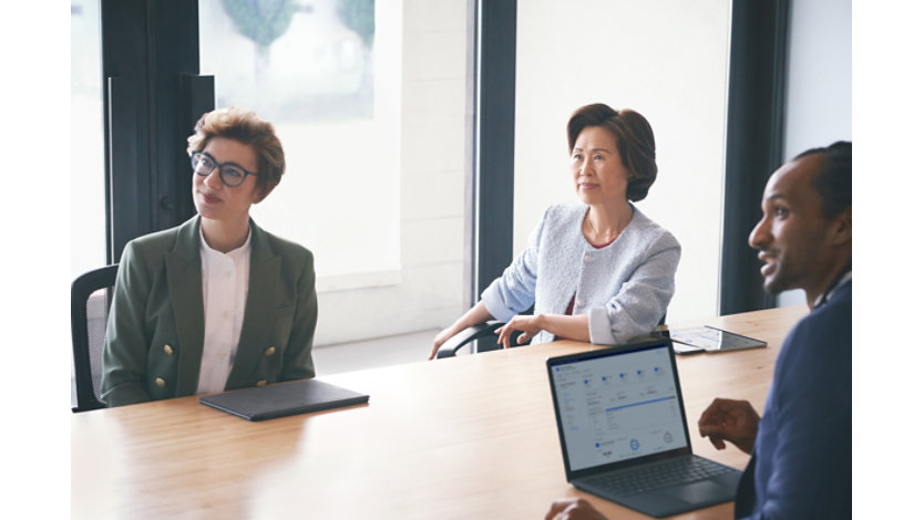Three people in a meeting.