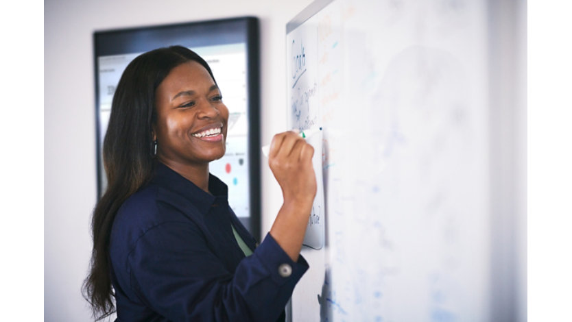 Woman drawing on a whiteboard.