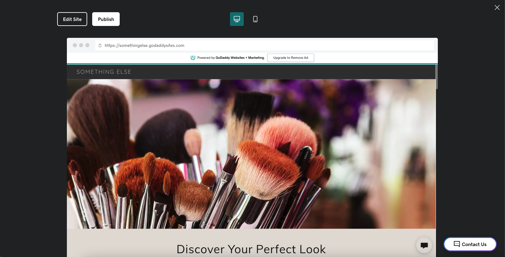 A screenshot of an example website built on GoDaddy, it has a dark grey surround with a large image if makeup brushes in the middle 