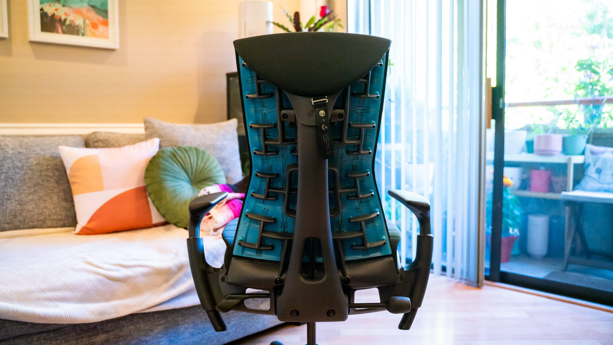 Rear of the Herman Miller x Logitech Embody showing blueish green patterning on the black office chair
