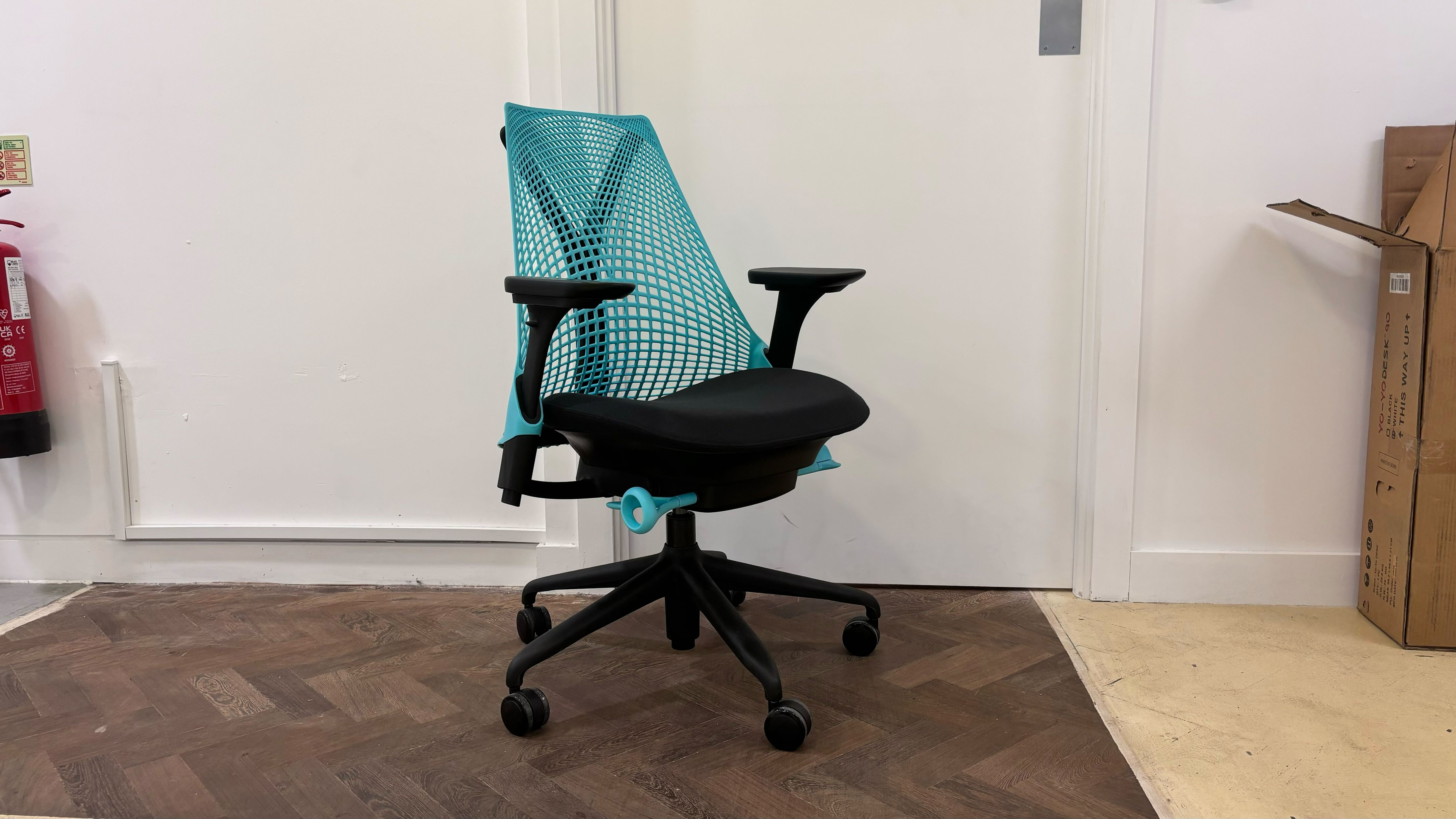 The Herman Miller Sayl Gaming Chair in a living room against a white door