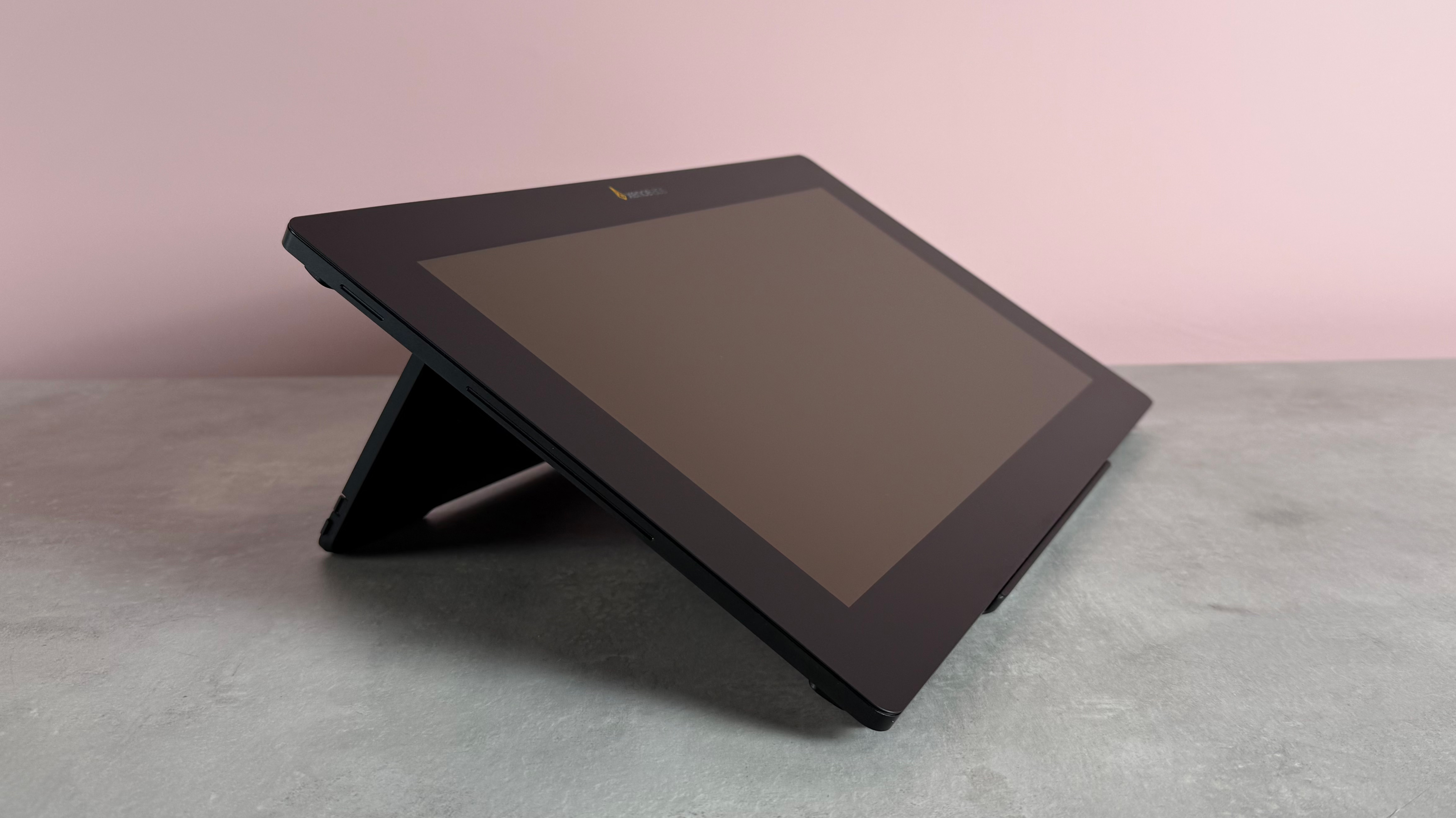 The Xencelabs Pen Display 16 in front of a pink background at a 3/4 angle.