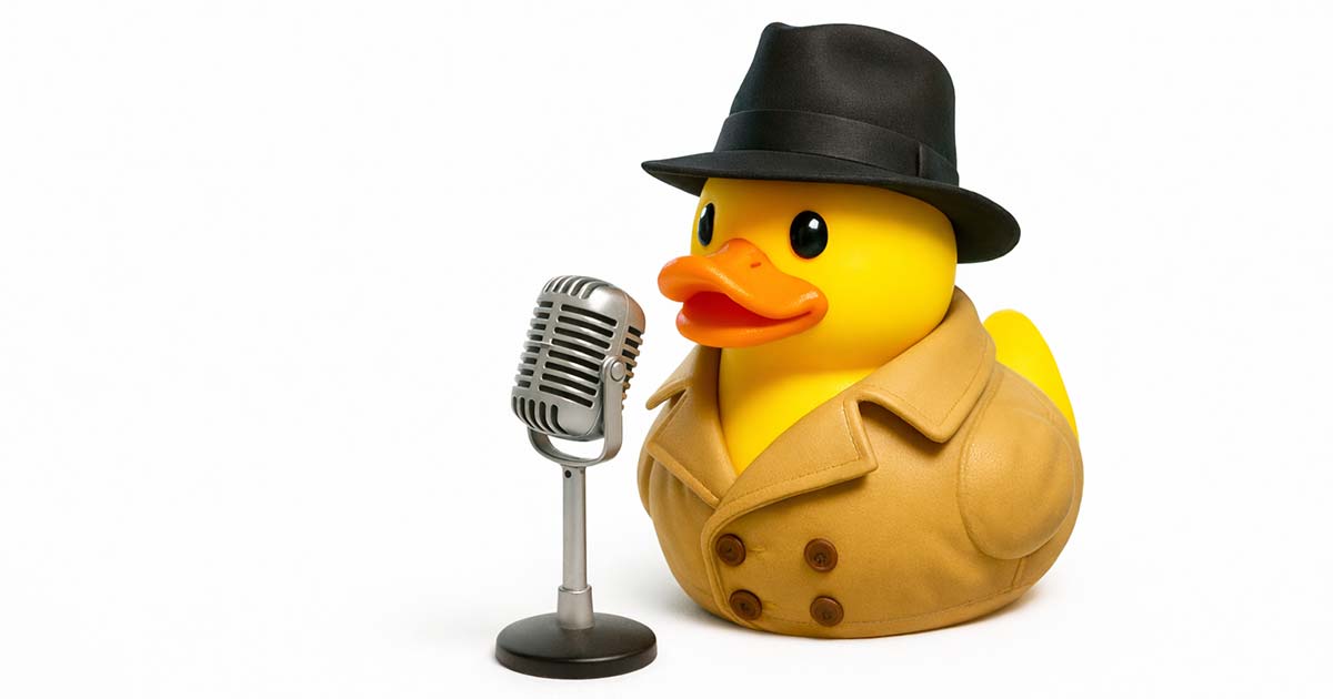 Rubber duck in fedora and trench coat stands next to a vintage microphone