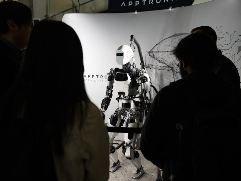 Crowd surrounding white humanoid robot