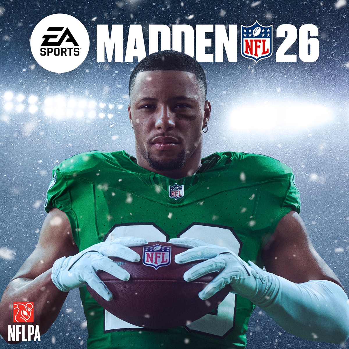 Madden NFL 26 Cover athlete Saquon Barkley wearing a green football uniform holds a football under stadium lights during snowfall, looking confidently into the camera.