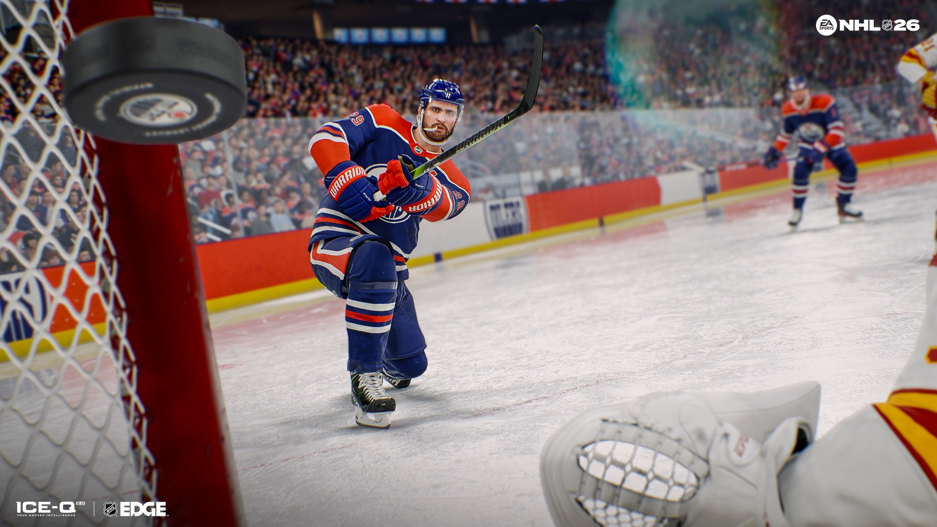 NHL 26 gameplay moment: Player Leon Draisaitl, in blue orange and white Edmonton Oilers uniform, shooting the puck into the goal