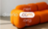 Floating domain extensions like .com, .net, and .org overlay an orange sofa, emphasizing choosing a custom domain.