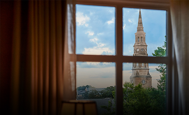 Close up of a window with a view of a tower