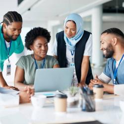 Doctors and nurses working on laptop