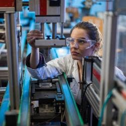 Quality control worker analyzing machine
