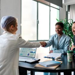 Businesswoman shaking hands with couple