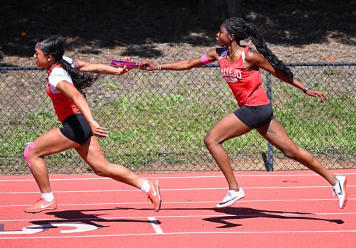 VHSTRACK1 Vallejo's Michesica Merisier makes the pass to Sidney Harris during the Women's Varsity 4x100 Relay at a TCAL Tri meet in Vallejo on Thursday. (Chris Riley/Times-Herald)