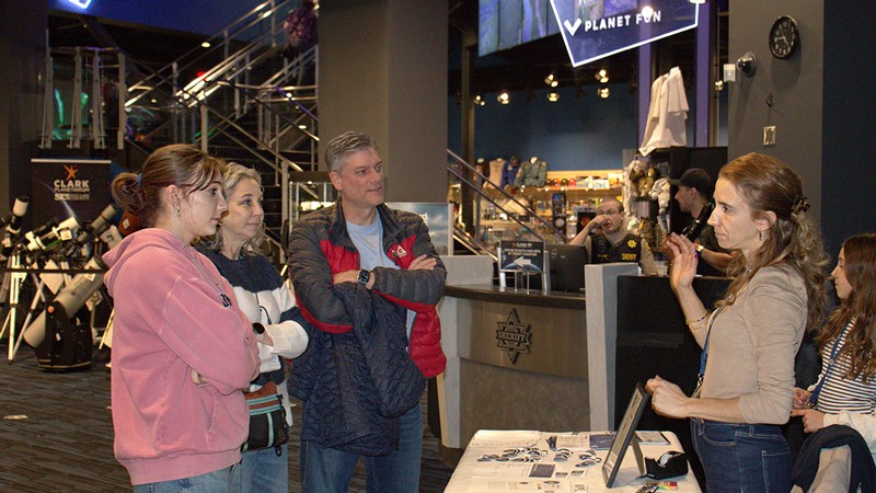 Full Size USU physicist Maria Rodriguez, right, talks with guests at the Women and Girls in Science Celebration on Feb. 6 at the Clark Planetarium in Salt Lake City. The event observed UNESCO's International Day of Women and Girls Day observed annually on Feb. 11. (Photo credit: USU/M. Muffoletto)